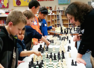 Children learning how to play chess afterschool program