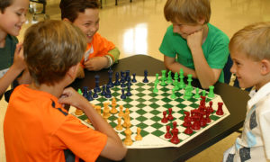 Students playing 4-way chess game