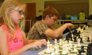 Student playing chess thinking about next move