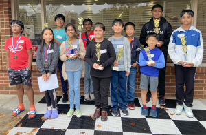 Kid Chess students holding trophies