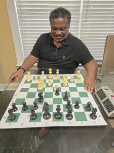 Man smiling playing chess